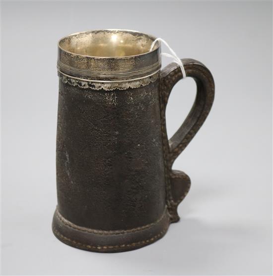 A Victorian silver and leather-covered black jack tankard, H 14.75cm